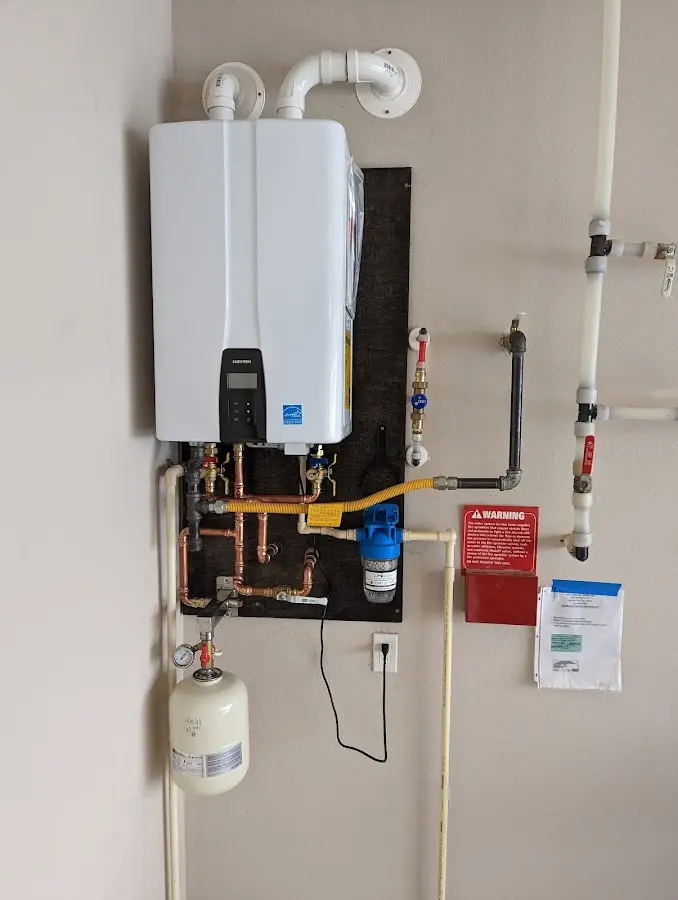 Professional plumber installing copper piping in a Golden Valley home